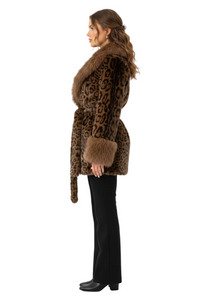 A woman shown in profile wearing a brown and black leopard-print faux fur coat with a matching fur collar, cuffs, and belt, paired with black pants and black shoes, against a plain white studio background.