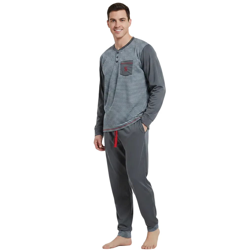 A man modeling a two-piece pajama set consisting of a long-sleeve henley shirt with gray and white horizontal stripes, a small red chest pocket, and matching gray jogger pants with a red drawstring, set against a plain white background.
