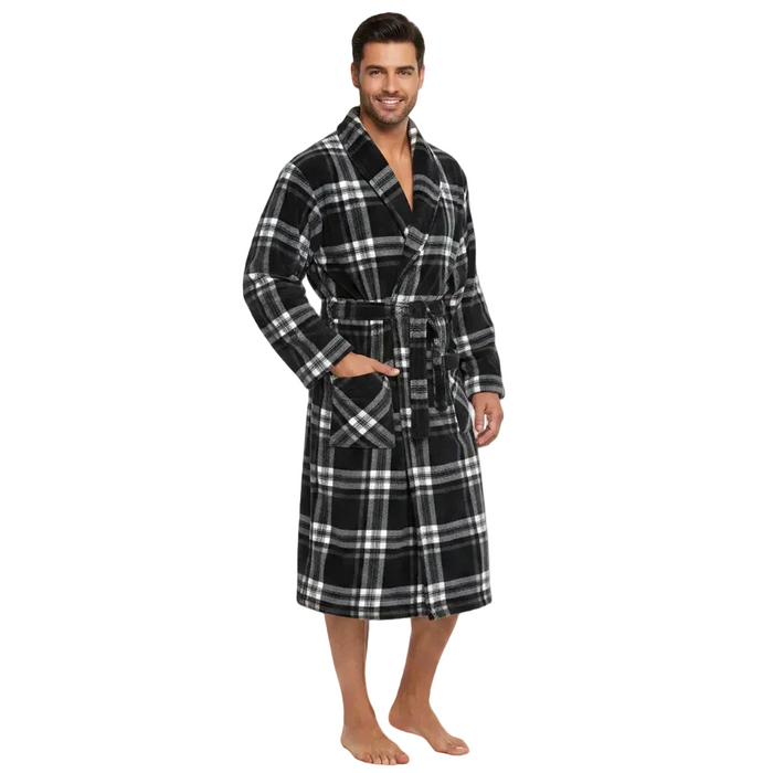 A man modeling a plush black and white plaid bathrobe against a solid white background.