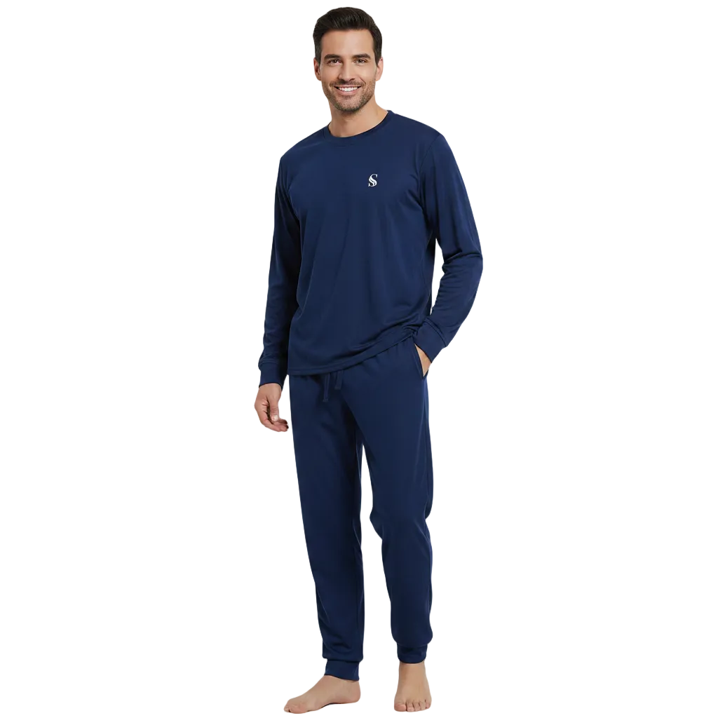 A man modeling a navy blue long-sleeve pajama set with matching jogger pants against a plain white background.