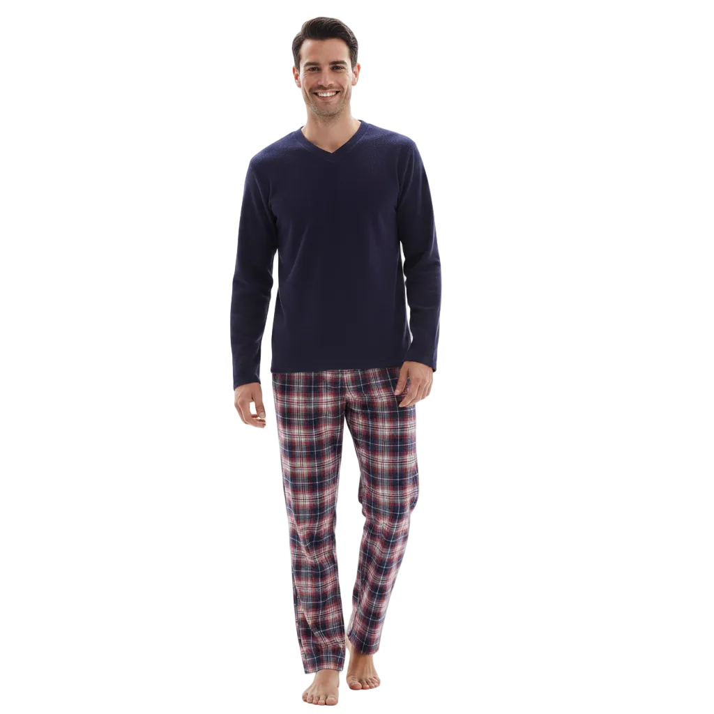 A man modeling a two-piece pajama set consisting of a navy blue long-sleeve V-neck shirt and red, blue, and white plaid pajama pants, set against a plain white background.