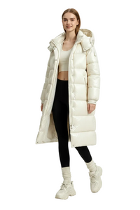 A model wearing a long, glossy off-white puffer coat over a beige crop top, black leggings, and chunky off-white sneakers, photographed against a seamless light gray studio background.
