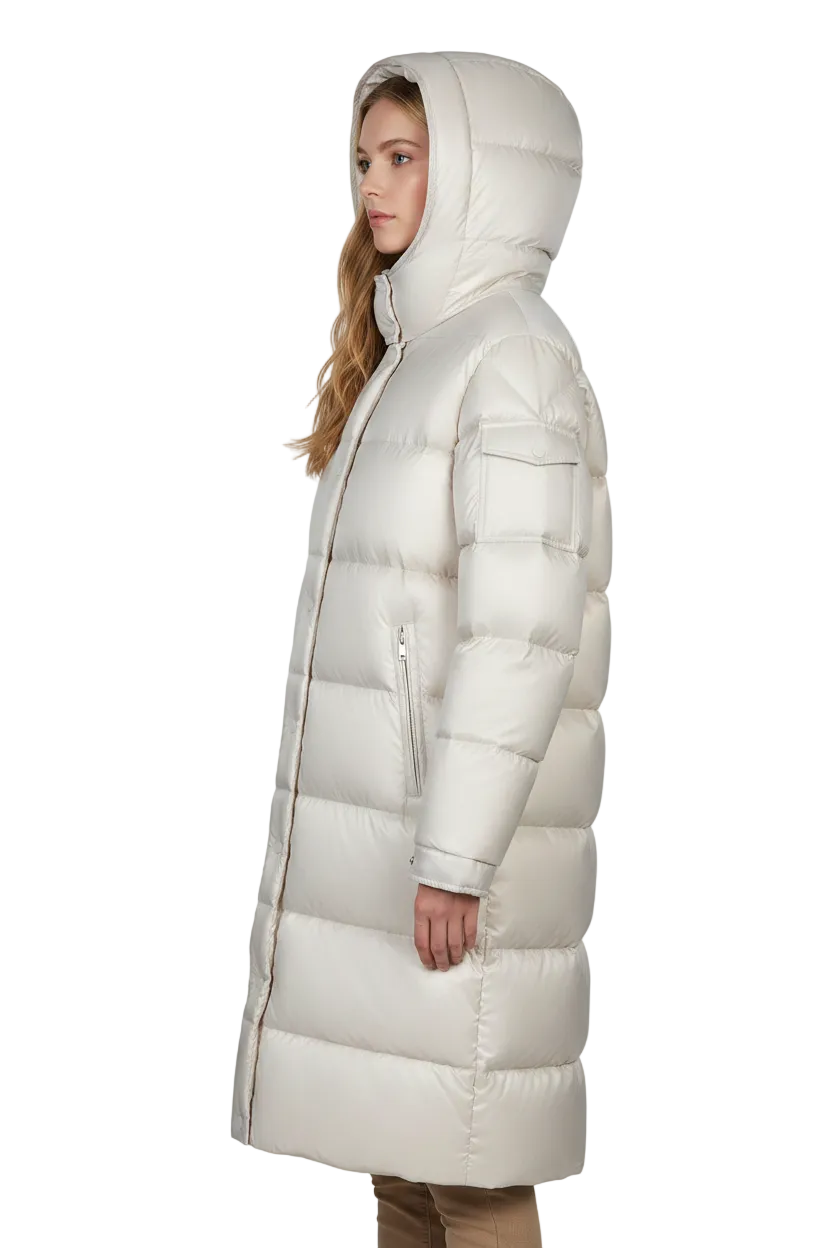 A woman wearing a long, hooded puffer coat in a warm off-white or cream color, shown in profile against a plain white studio background.