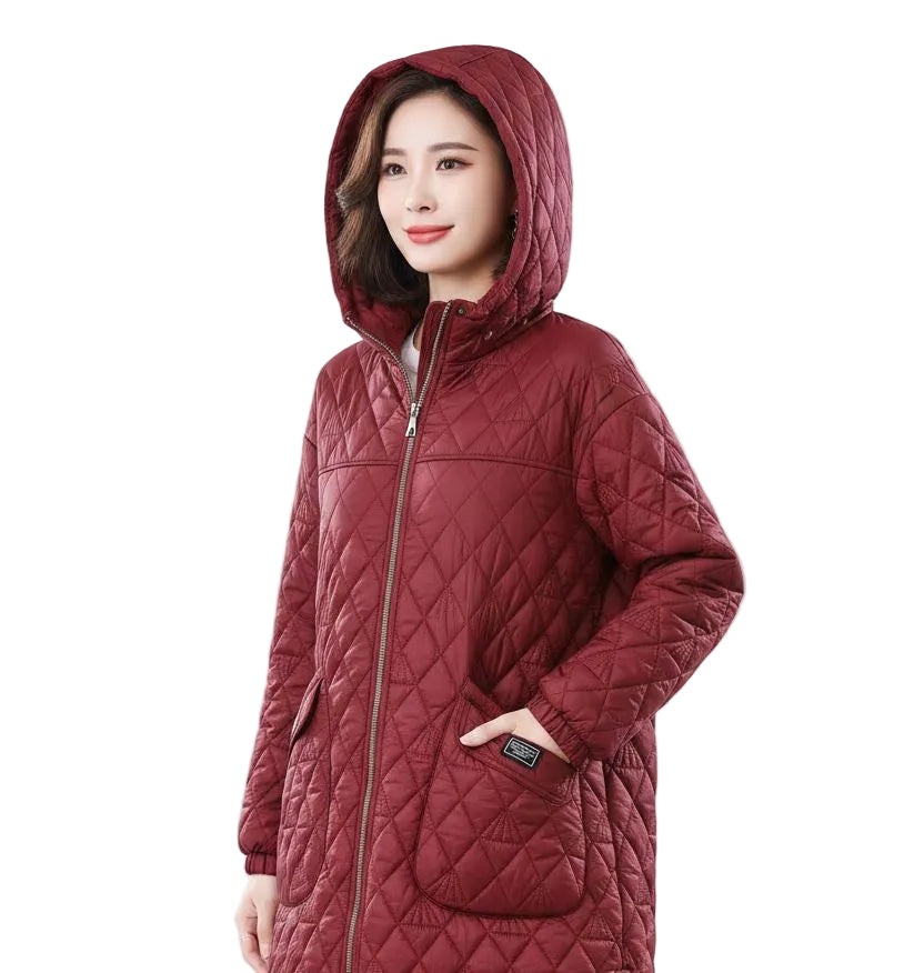 A woman wearing a long quilted hooded puffer coat in a deep burgundy red, shown from the waist up against a plain white background.