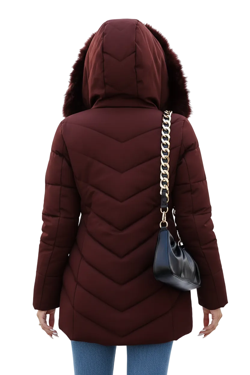 A woman shown from the back wearing a dark burgundy hooded puffer jacket with faux fur trim, blue jeans, and carrying a black shoulder bag with a gold chain strap against a plain white background.