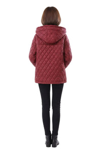 A woman viewed from behind wearing a quilted burgundy hooded jacket, black leggings, and black boots against a plain white background.