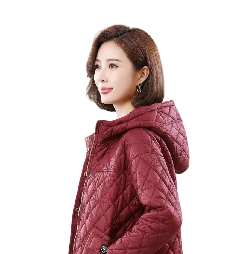 A woman wearing a quilted hooded jacket in a deep burgundy red, shown from a side profile against a plain white background.