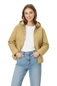 A woman modeling a light tan quilted hooded jacket over a white t-shirt and light blue jeans, photographed against a solid white background.